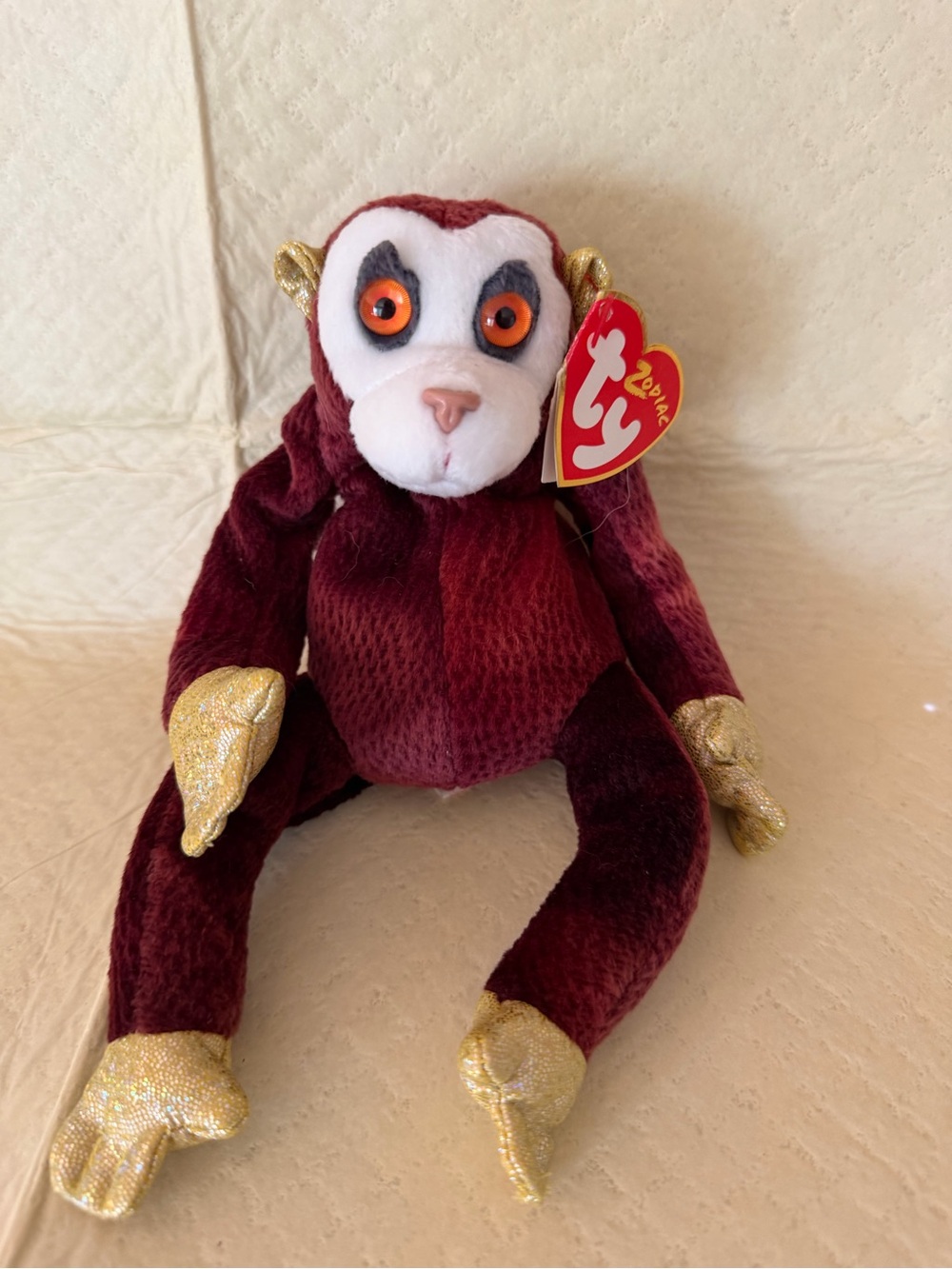 Ty Burgundy Monkey Plush with Gold Accents and Orange Eyes